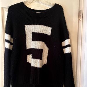 Black and white sweater with the number 5